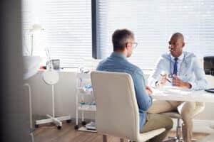 A patient talking to a cosmetic surgeon