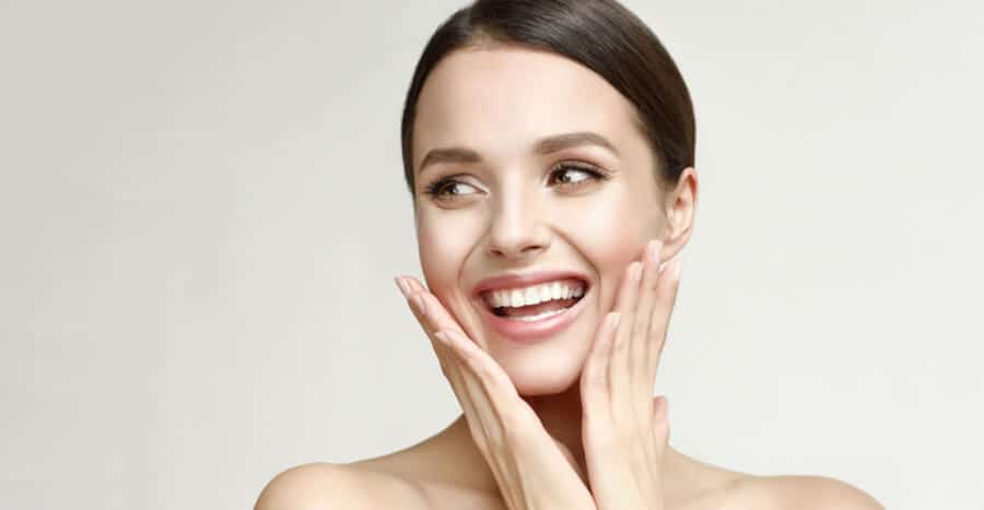 Woman smiling, showcasing youthful skin after Plasma Pen treatment.
